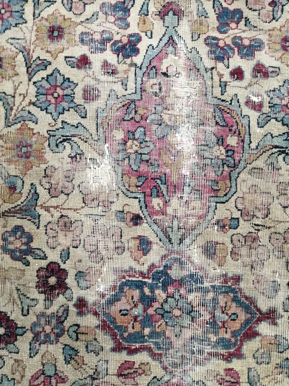 A Persian ivory ground carpet with central medallion of floral motifs, multi-bordered, 400 x 291cm